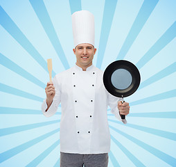 Image showing happy male chef holding frying pan and spatula
