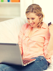 Image showing happy woman with laptop computer and credit card