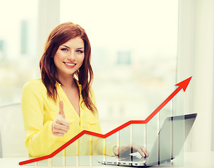 Image showing smiling woman with laptop and growth chart