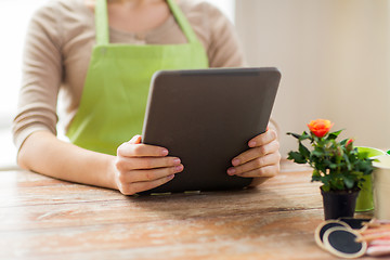 Image showing close up of woman or gardener holding tablet pc