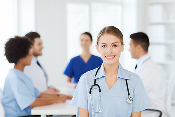 Image showing happy doctor over group of medics at hospital