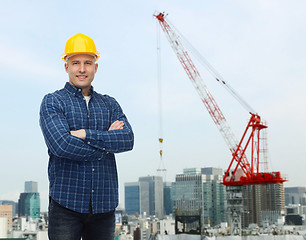 Image showing smiling male builder or manual worker in helmet