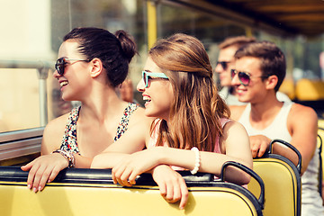 Image showing group of smiling friends traveling by tour bus