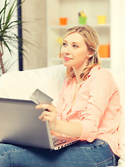 Image showing happy woman with laptop computer and credit card