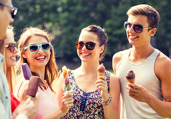 Image showing group of smiling friends with ice cream outdoors