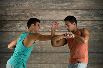 Image showing young men fighting hand-to-hand