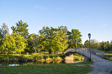 Image showing Foot bridge through river in city park