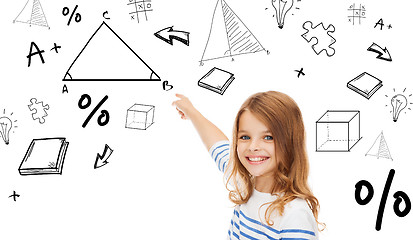 Image showing girl pointing to triangle on virtual screen