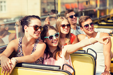 Image showing group of smiling friends traveling by tour bus