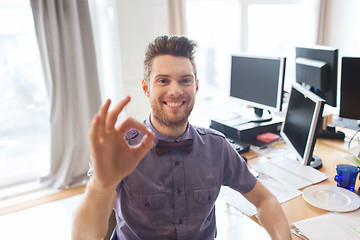 Image showing happy creative male office worker showing ok sign