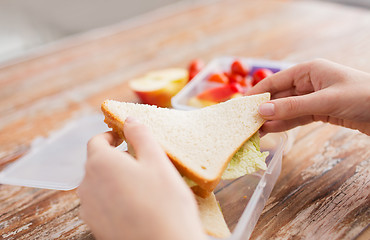 Image showing close up of woman with food in plastic container