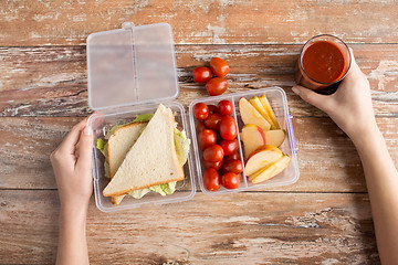 Image showing close up of woman with food in plastic container