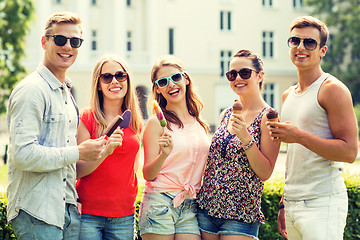 Image showing group of smiling friends with ice cream outdoors