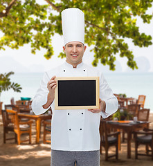 Image showing happy male chef cook holding blank menu board
