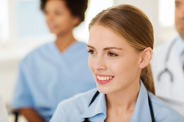 Image showing happy doctor over group of medics at hospital