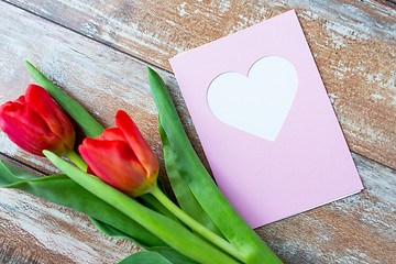 Image showing close up of tulips and greeting card with heart