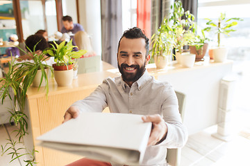 Image showing happy creative male office worker with folfer