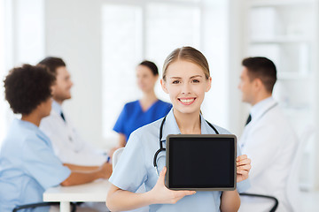 Image showing happy doctor over group of medics at hospital