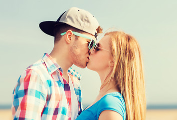 Image showing teenage couple kissing outdoors
