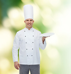 Image showing happy male chef cook showing empty plate