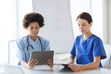 Image showing doctors with tablet pc meeting at hospital