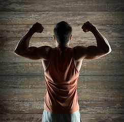 Image showing young man or bodybuilder showing biceps