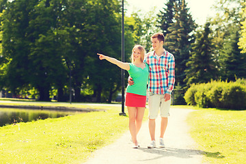 Image showing smiling couple walking in park