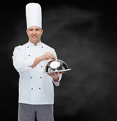 Image showing happy male chef cook holding cloche