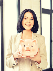 Image showing lovely woman with piggy bank