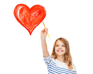 Image showing cute little girl drawing heart with brush