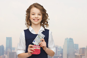 Image showing happy girl with purse and paper money