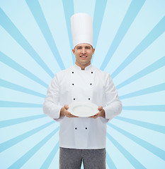 Image showing happy male chef cook showing empty plate