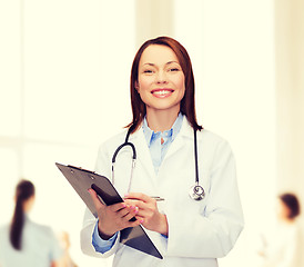 Image showing smiling female doctor with clipboard