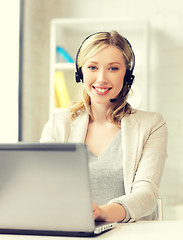 Image showing friendly female helpline operator with laptop