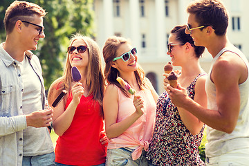 Image showing group of smiling friends with ice cream outdoors