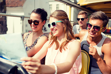 Image showing group of smiling friends traveling by tour bus