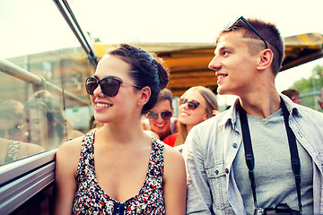 Image showing smiling couple with camera traveling by tour bus