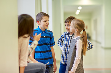 Image showing group of smiling school kids talking in corridor