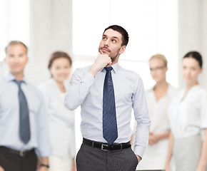 Image showing handsome businessman looking up