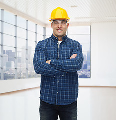 Image showing smiling male builder or manual worker in helmet