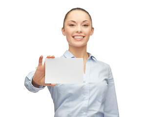 Image showing smiling businesswoman showing white blank card