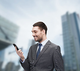 Image showing young smiling businessman with smartphone