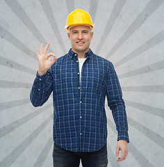 Image showing smiling male builder in helmet showing ok sign