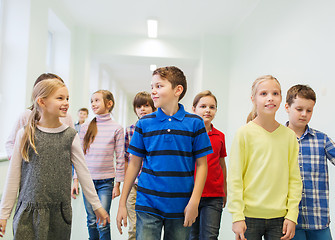 Image showing group of smiling school kids walking in corridor