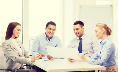 Image showing smiling business team having discussion in office