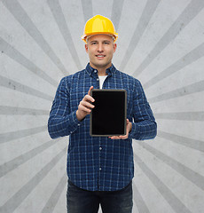 Image showing smiling male builder in helmet with tablet pc