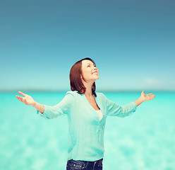 Image showing smiling woman waving hands