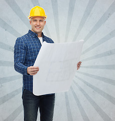 Image showing smiling male builder in helmet with blueprint