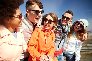 Image showing smiling friends in sunglasses laughing on street