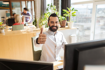 Image showing happy male office worker showing thumbs up